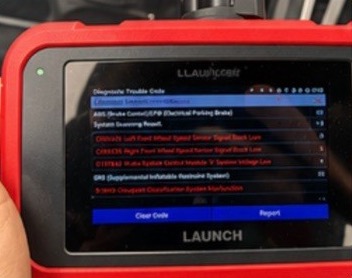OBD scanner showing multiple diagnostic trouble codes